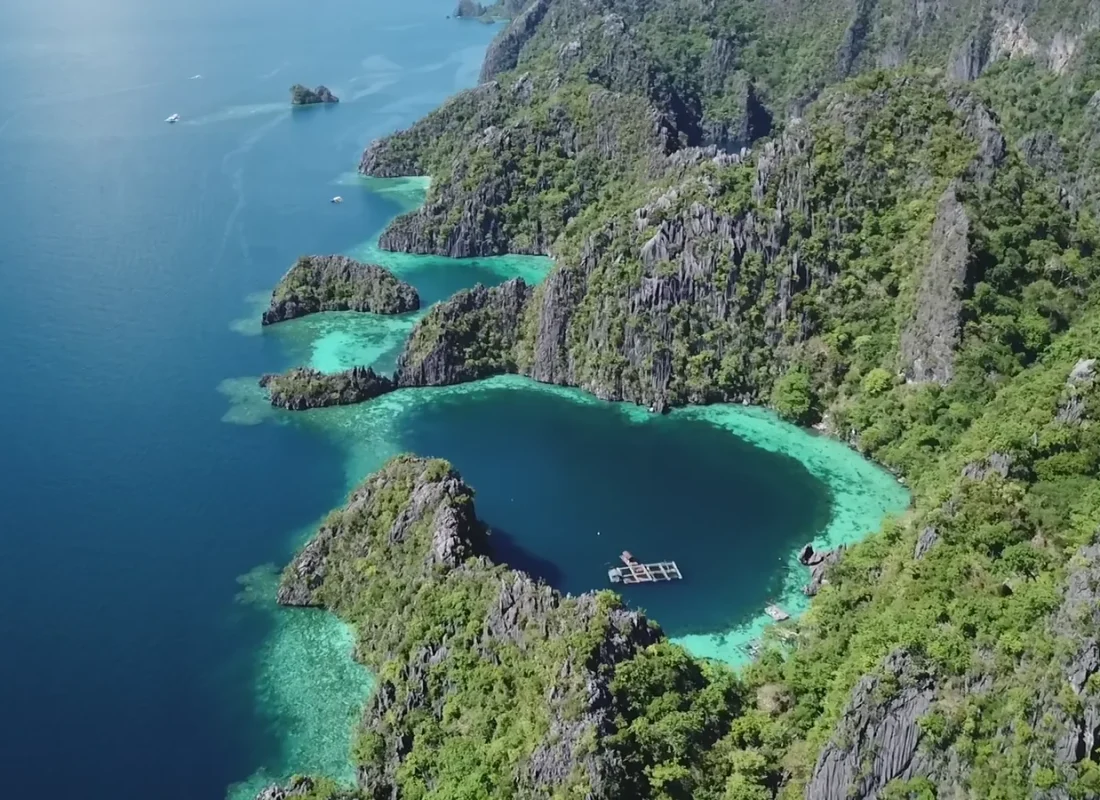 Aerial view of Palawan’s limestone islands and turquoise lagoons for Coral Crown Adventures.
